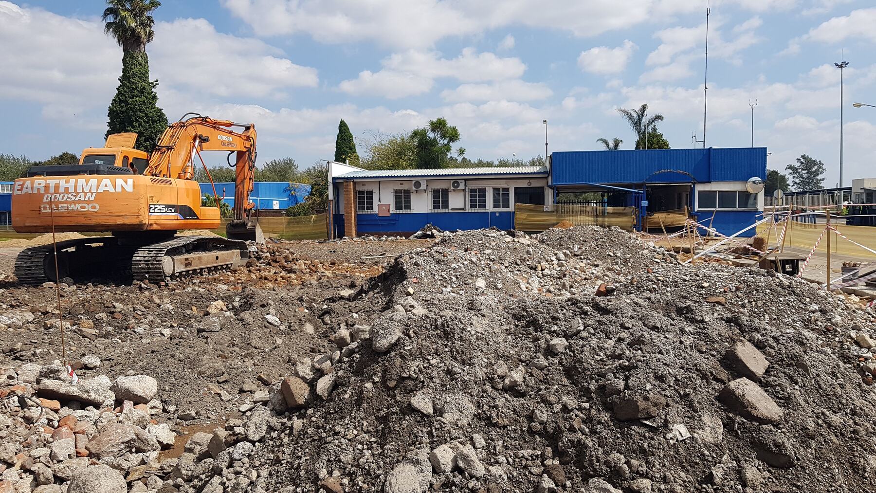 Excavator breaking rock during bulk earthworks on an RNC Group main contract site
