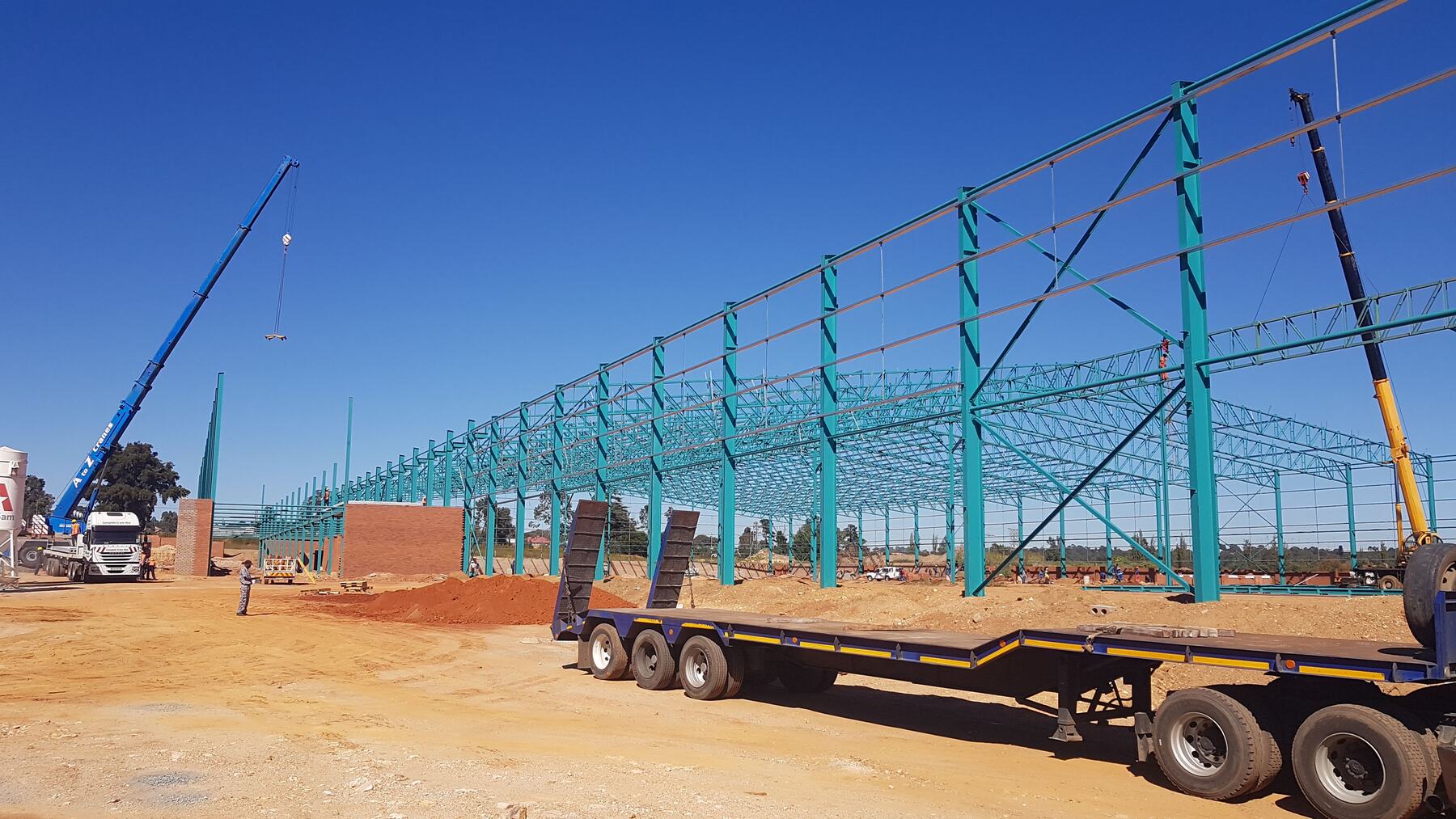 Cranes lifting structural steel into place on an RNC Group main contract site